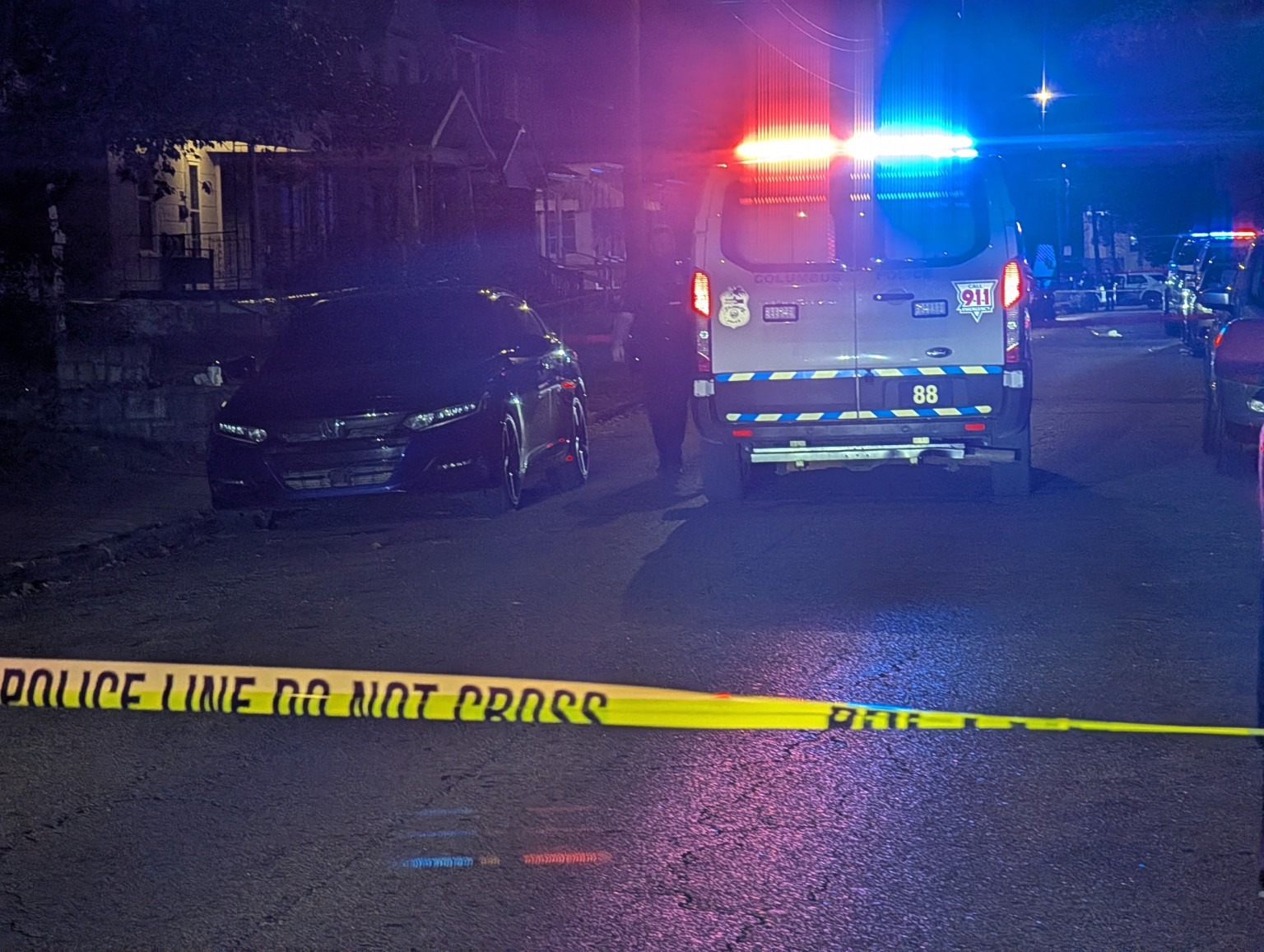Emergency vehicles seen behind yellow tape.